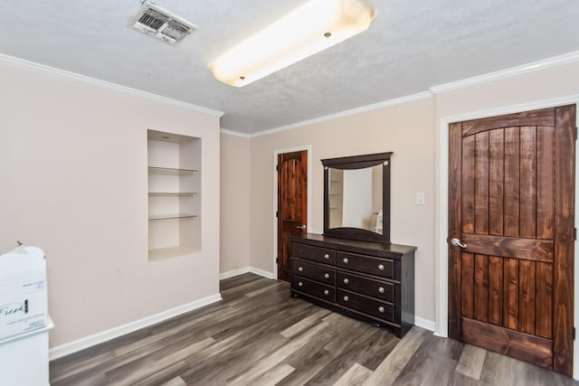 bedroom with a textured ceiling, crown molding, and dark hardwood / wood-style floors