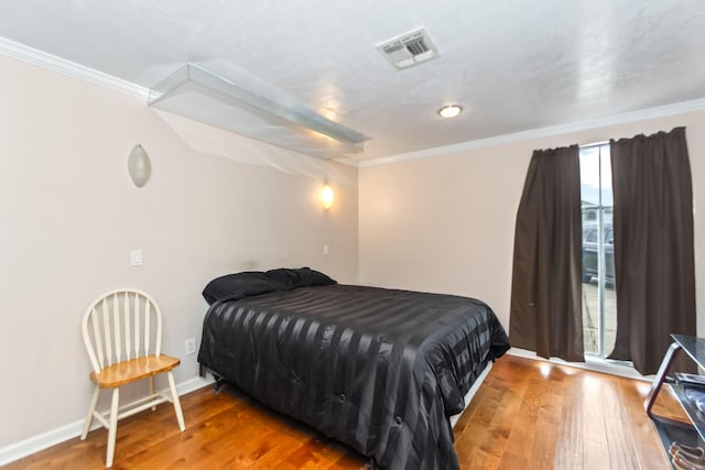 bedroom with wood-type flooring and crown molding