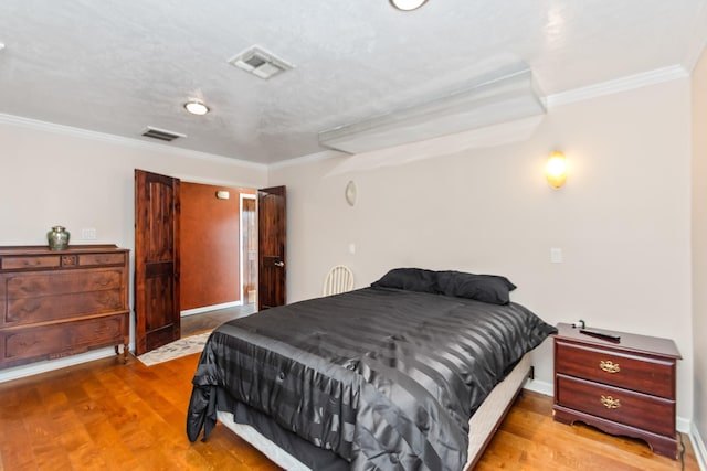 bedroom featuring ornamental molding and hardwood / wood-style flooring