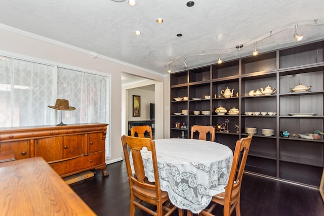 dining area with built in features, dark hardwood / wood-style flooring, ornamental molding, and a textured ceiling