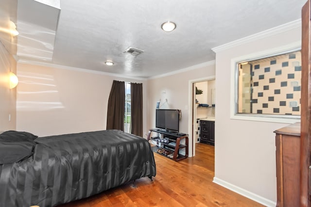 bedroom featuring hardwood / wood-style floors and crown molding