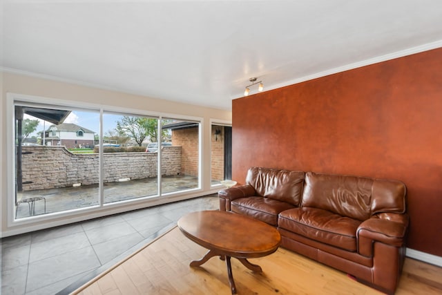 living room with hardwood / wood-style flooring and crown molding