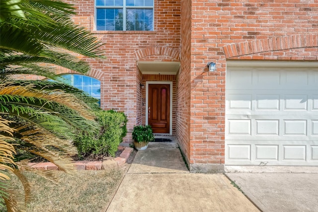 doorway to property with a garage