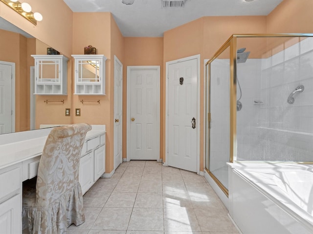 bathroom featuring tile patterned floors, vanity, and walk in shower