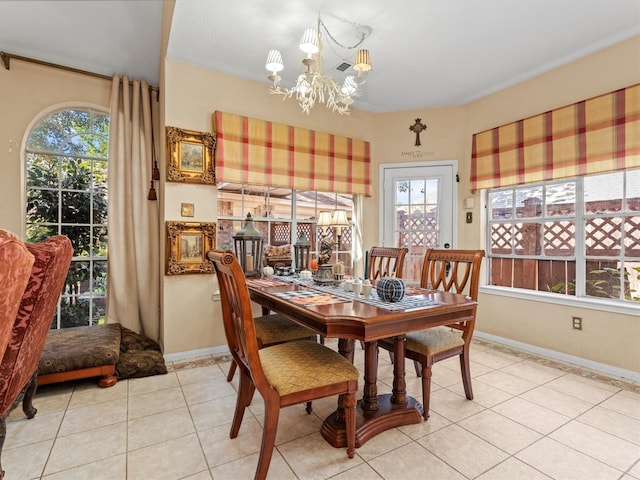 tiled dining area featuring an inviting chandelier