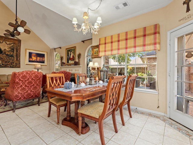 dining room with lofted ceiling, light tile patterned floors, and an inviting chandelier