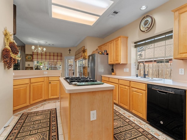 kitchen featuring sink, an inviting chandelier, kitchen peninsula, a kitchen island, and appliances with stainless steel finishes