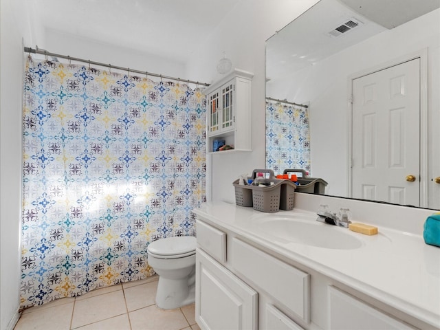 bathroom featuring tile patterned floors, vanity, curtained shower, and toilet