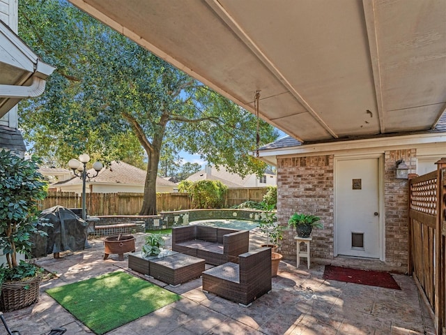 view of patio / terrace with an outdoor living space with a fire pit