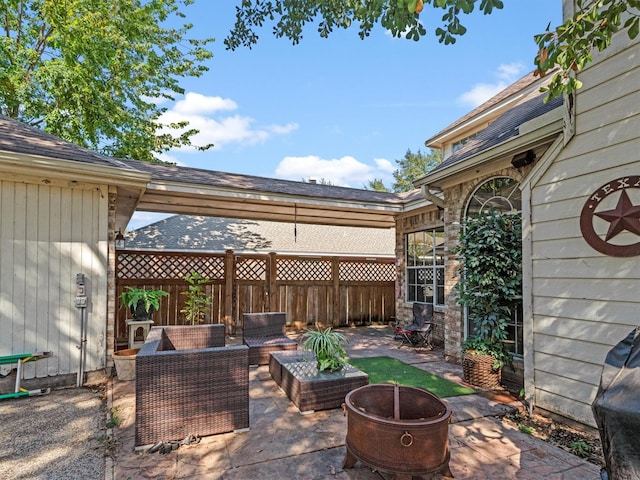 view of patio / terrace with an outdoor living space with a fire pit