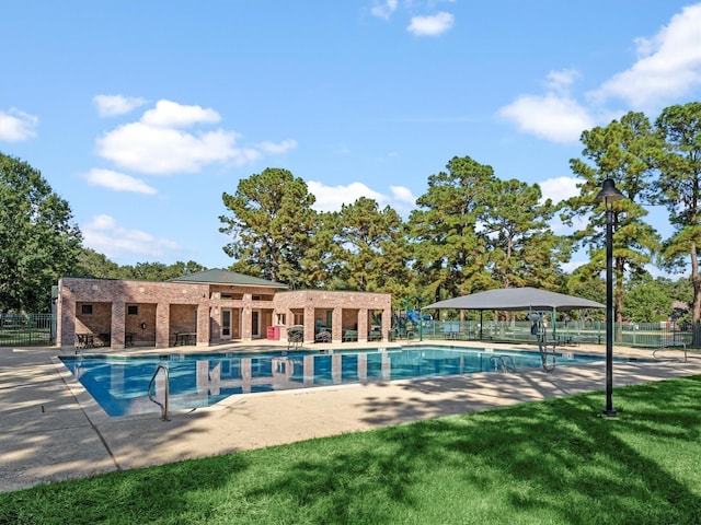 view of pool featuring a yard