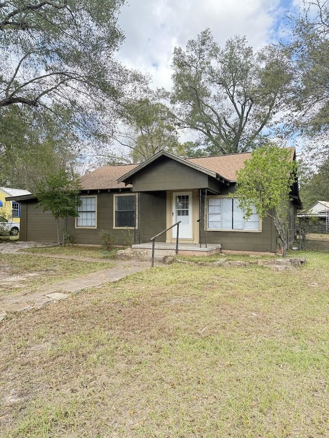 ranch-style home with a front lawn