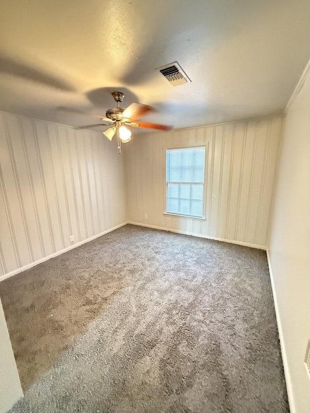 empty room featuring carpet and ceiling fan