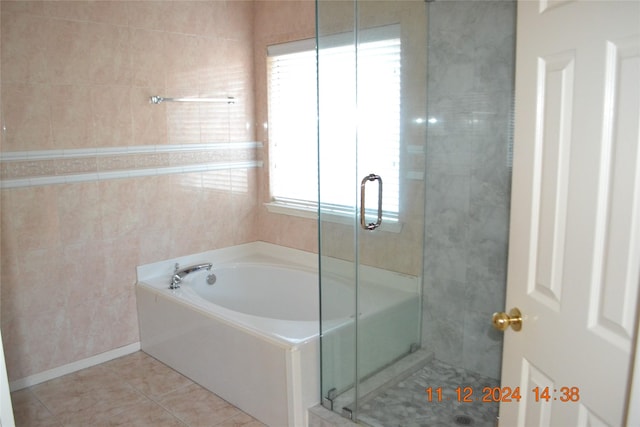 bathroom with tile patterned floors and plus walk in shower