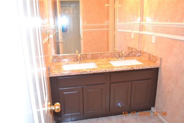 bathroom featuring tile patterned floors, vanity, and tile walls