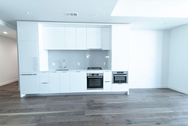 kitchen featuring white cabinetry, sink, dark hardwood / wood-style floors, and appliances with stainless steel finishes