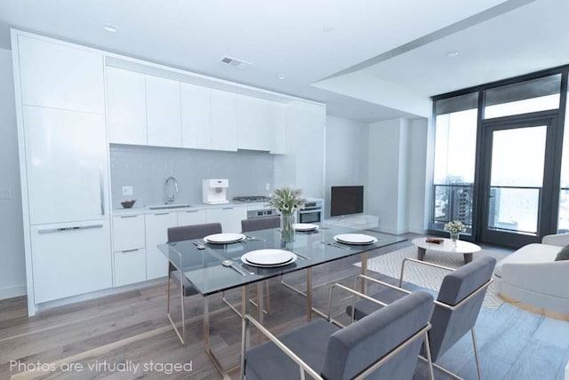 dining space featuring light hardwood / wood-style floors and sink