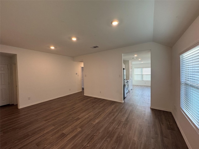 spare room with lofted ceiling and dark hardwood / wood-style floors