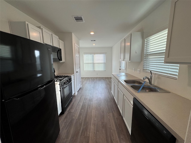 kitchen featuring black appliances, white cabinetry, sink, and dark wood-type flooring