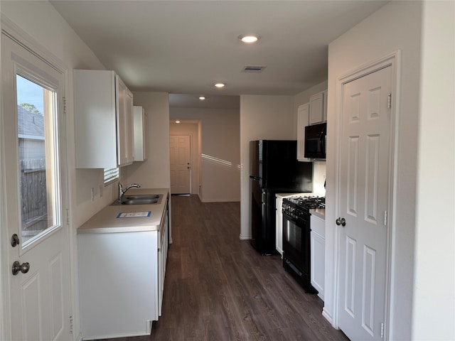 kitchen featuring black appliances, dark hardwood / wood-style floors, white cabinetry, and sink