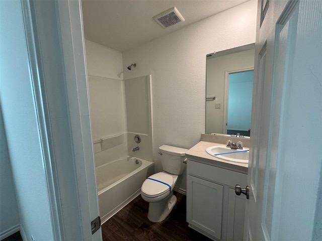 full bathroom with washtub / shower combination, hardwood / wood-style floors, vanity, and toilet