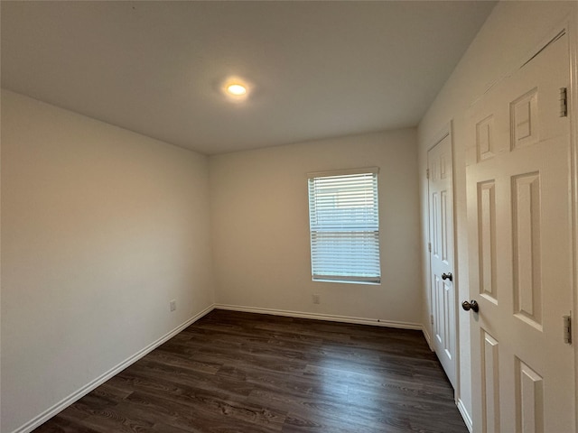 empty room featuring dark wood-type flooring