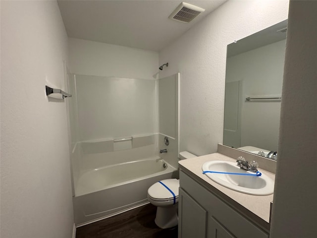 full bathroom featuring toilet, vanity, bathtub / shower combination, and hardwood / wood-style flooring