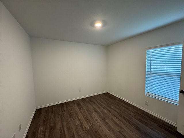 empty room with dark hardwood / wood-style floors