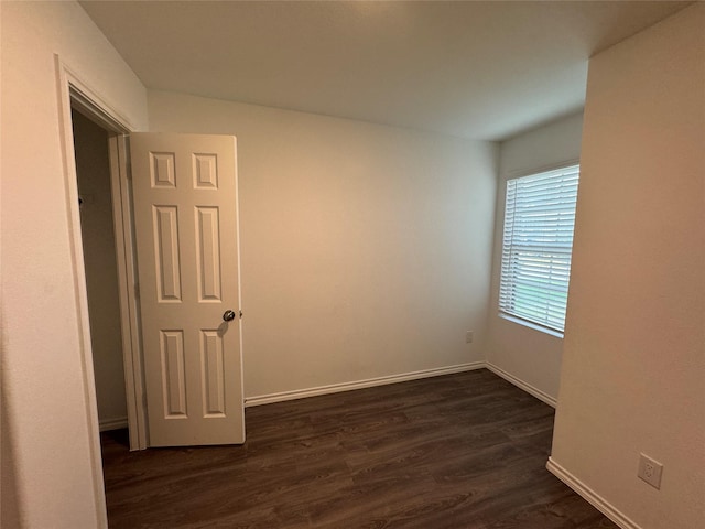 empty room with dark hardwood / wood-style floors