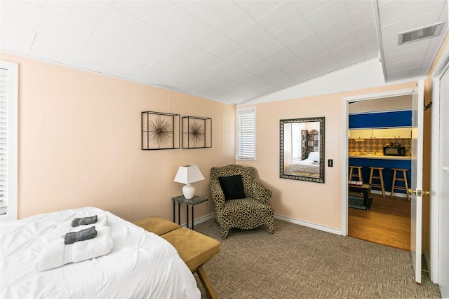 bedroom with hardwood / wood-style flooring and lofted ceiling