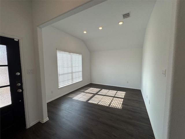 foyer featuring dark hardwood / wood-style floors and vaulted ceiling