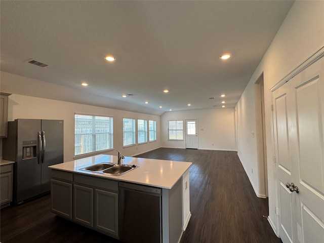 kitchen featuring an island with sink, stainless steel appliances, plenty of natural light, and sink