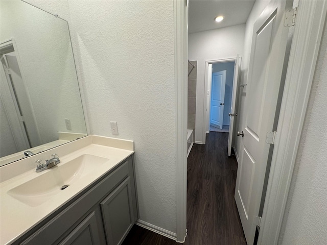 bathroom with hardwood / wood-style floors and vanity