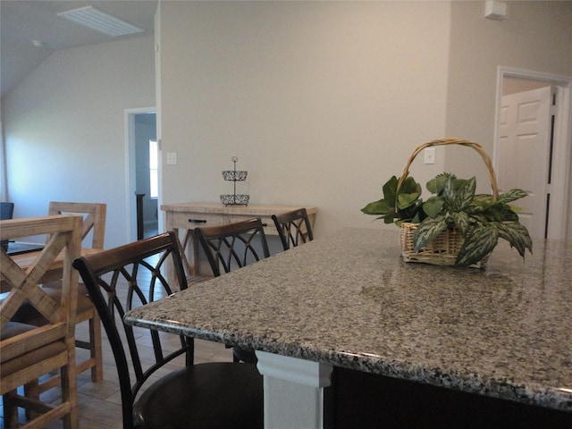 dining room with vaulted ceiling