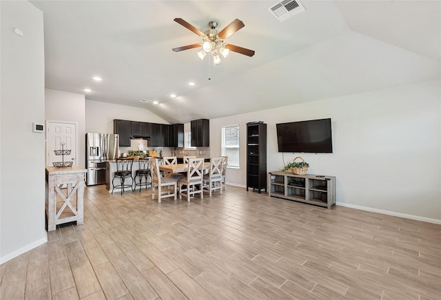 interior space featuring ceiling fan, light hardwood / wood-style flooring, and vaulted ceiling