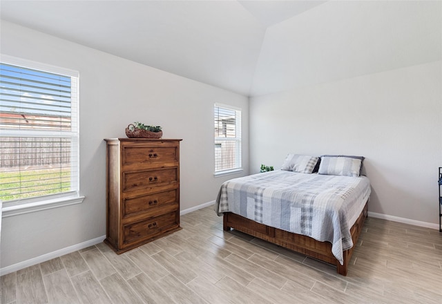 bedroom featuring light hardwood / wood-style flooring and vaulted ceiling