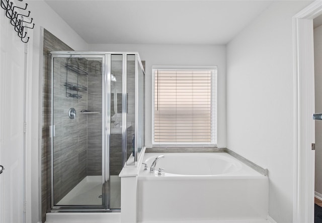 bathroom with shower with separate bathtub