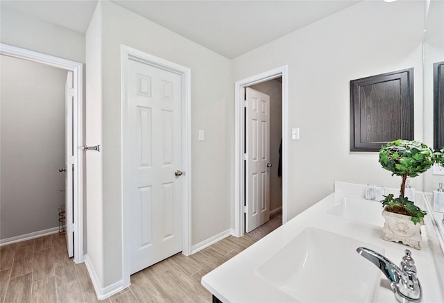 bathroom with vanity and wood-type flooring