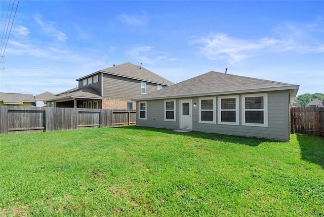 back of house featuring a yard