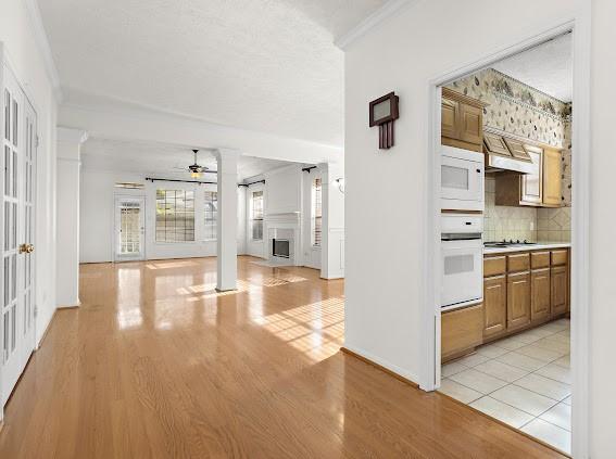 interior space featuring crown molding and light hardwood / wood-style flooring