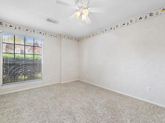 empty room with carpet and ceiling fan