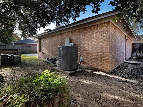 view of side of home with central AC