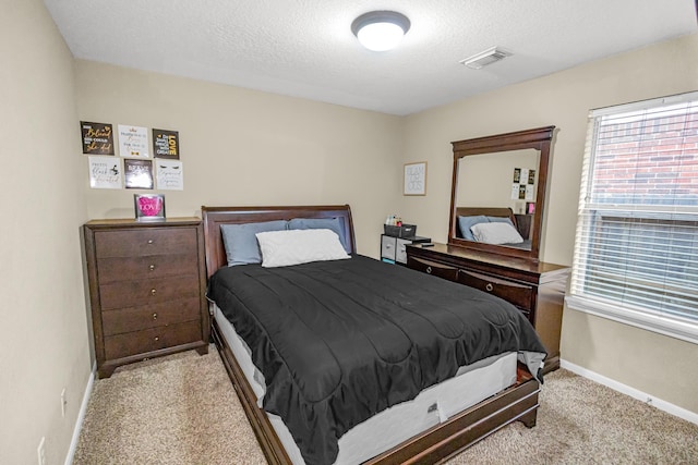 carpeted bedroom featuring a textured ceiling