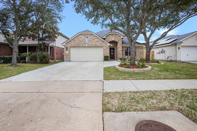 view of front of house featuring a front yard and a garage