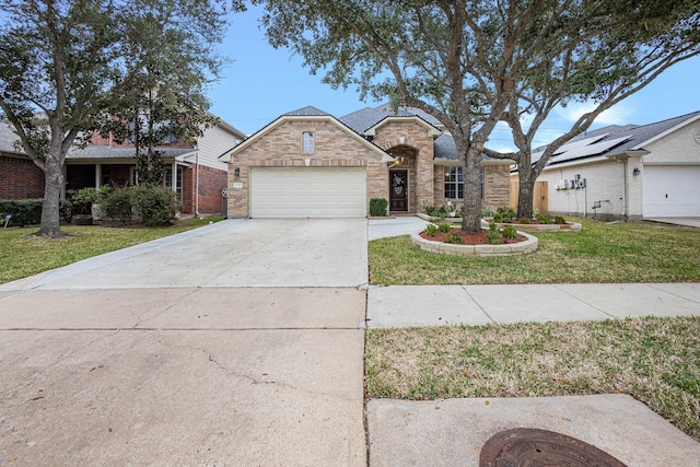 view of front of house featuring a garage and a front yard