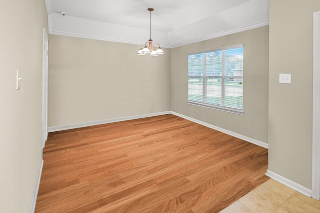 unfurnished room featuring ornamental molding, light hardwood / wood-style floors, and a chandelier