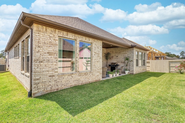 view of side of property with a yard and cooling unit