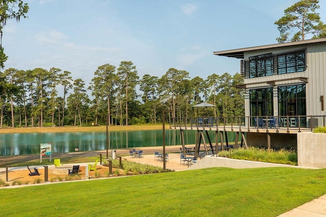 view of community featuring a water view and a lawn