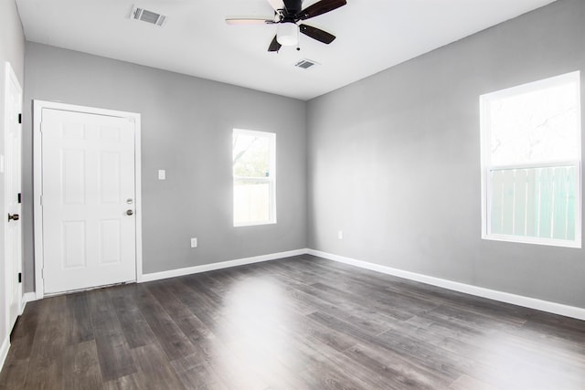 spare room featuring ceiling fan and dark wood-type flooring