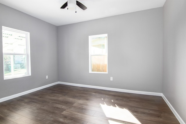 empty room featuring dark hardwood / wood-style flooring and ceiling fan